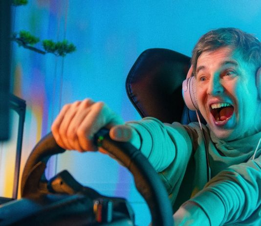 Pro Gamer Man playing computer games. Car Racing Online Video Game