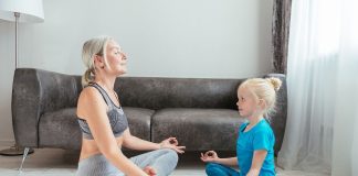 The half lotus pose (Ardha Padmasana) is an effective hip opener pose. (Photo by Mikhail Nilov via pexels)