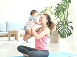 mother exercising postpartum with baby