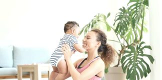 mother exercising postpartum with baby