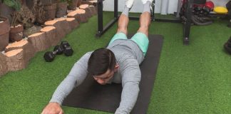 a photo of a man doing the superman exercise