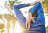 Why do muscles get sore after exercise? Image shows man stretching