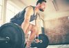 Man demonstrating how to deadlift using barbell