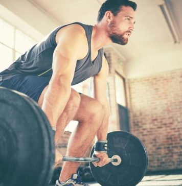 Man demonstrating how to deadlift using barbell