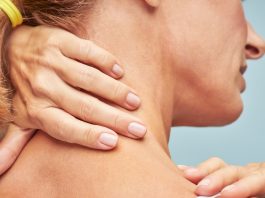 Close-up of woman with hands on back of neck