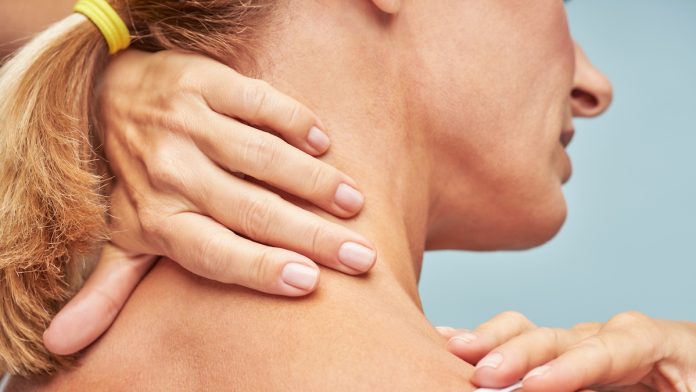 Close-up of woman with hands on back of neck